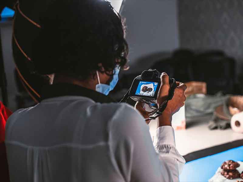 Photographer capturing food photos in a product photography studio