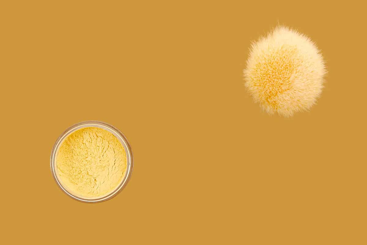 powder-fluffy-brush-beige-background